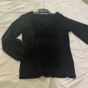 Beautiful black blouse with sheer sleeves.
